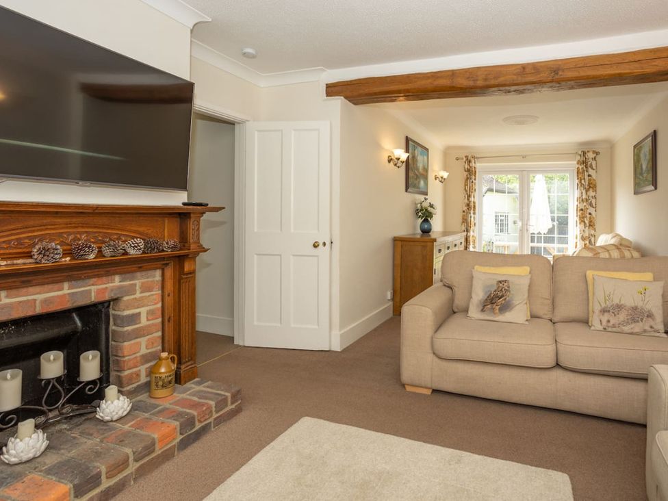 A living room with a television and sofa at The Old Barn in Manchester