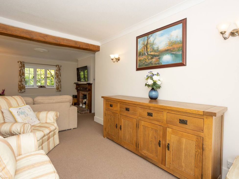 A living room with a sofa and a TV at The Old Barn in Manchester