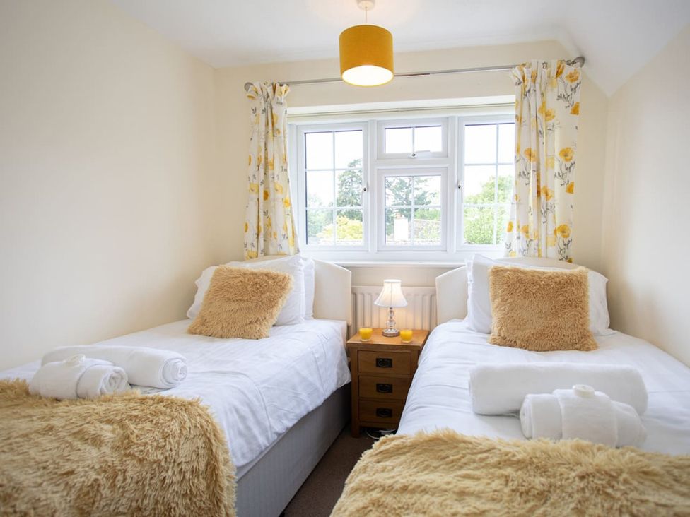A bedroom with two beds and a window at a property