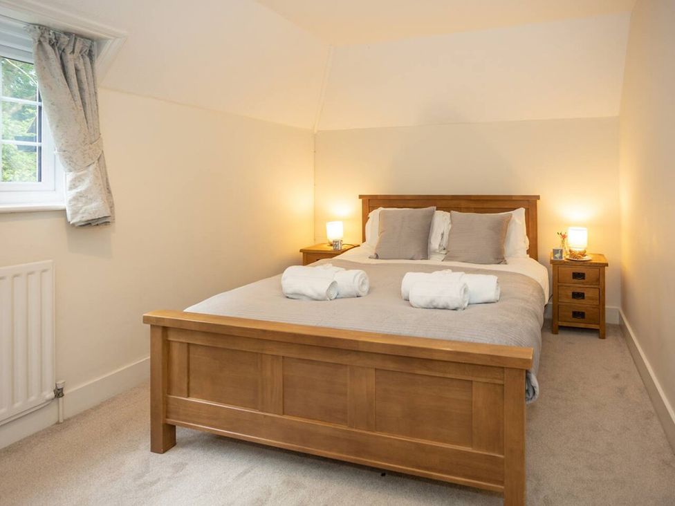 A bedroom with a bed and bedside tables at The Old Barn in Manchester