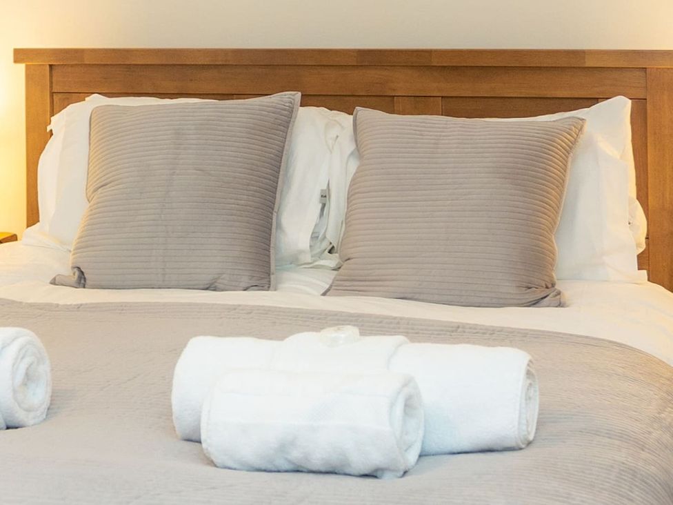 A bedroom with a bed and pillows at The Old Barn in Manchester