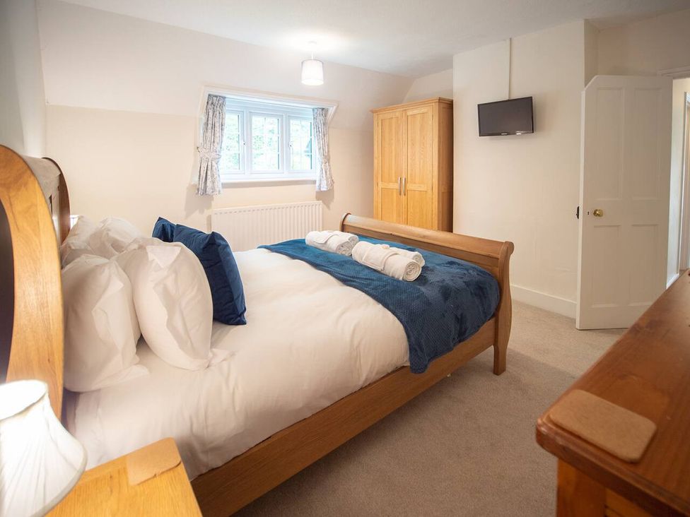 A bedroom with a bed and television at The Old Barn in Manchester