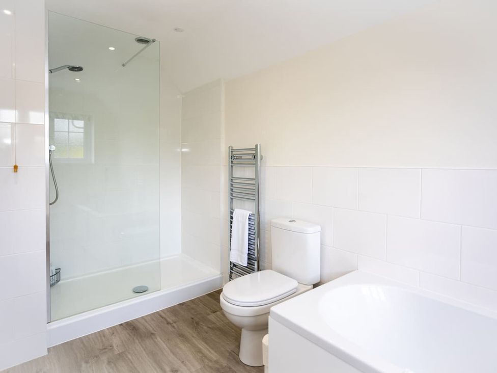 A bathroom with a shower, toilet and bathtub at The Old Barn in Manchester