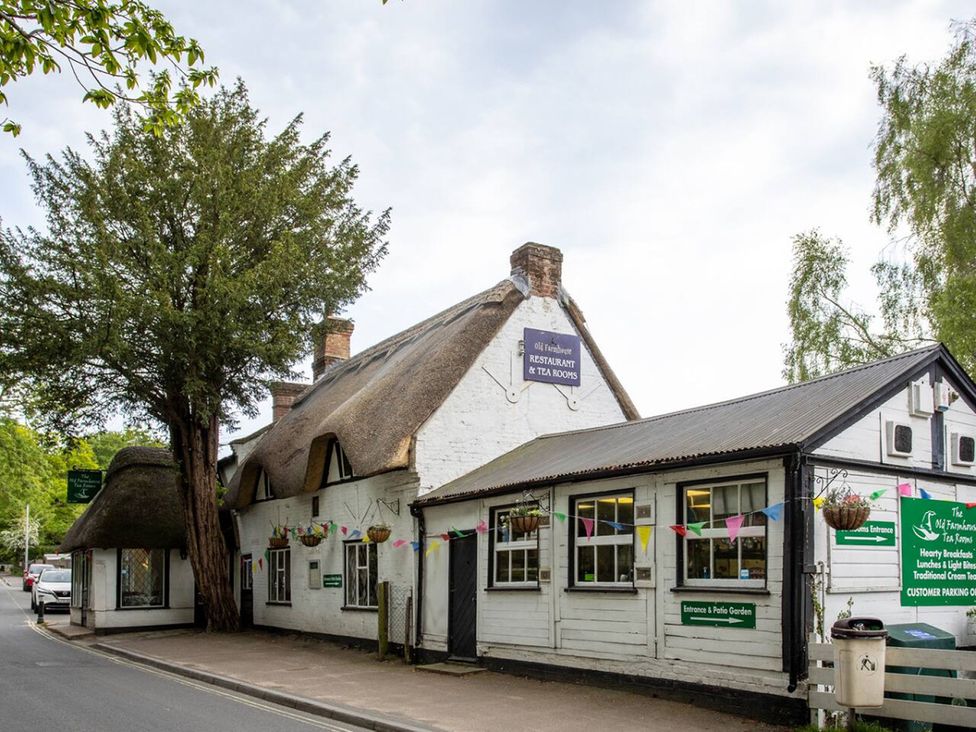 A restaurant and tea room with signage and trees at The Old Farmhouse in an outdoor location