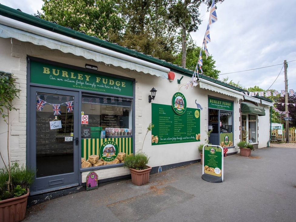 Shop front of Burley Fudge with flower pots and signage at Burley Fudge in Burley