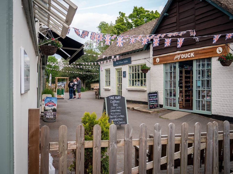 An outdoor shopping area with shops and people at the Duck in Oxfordshire