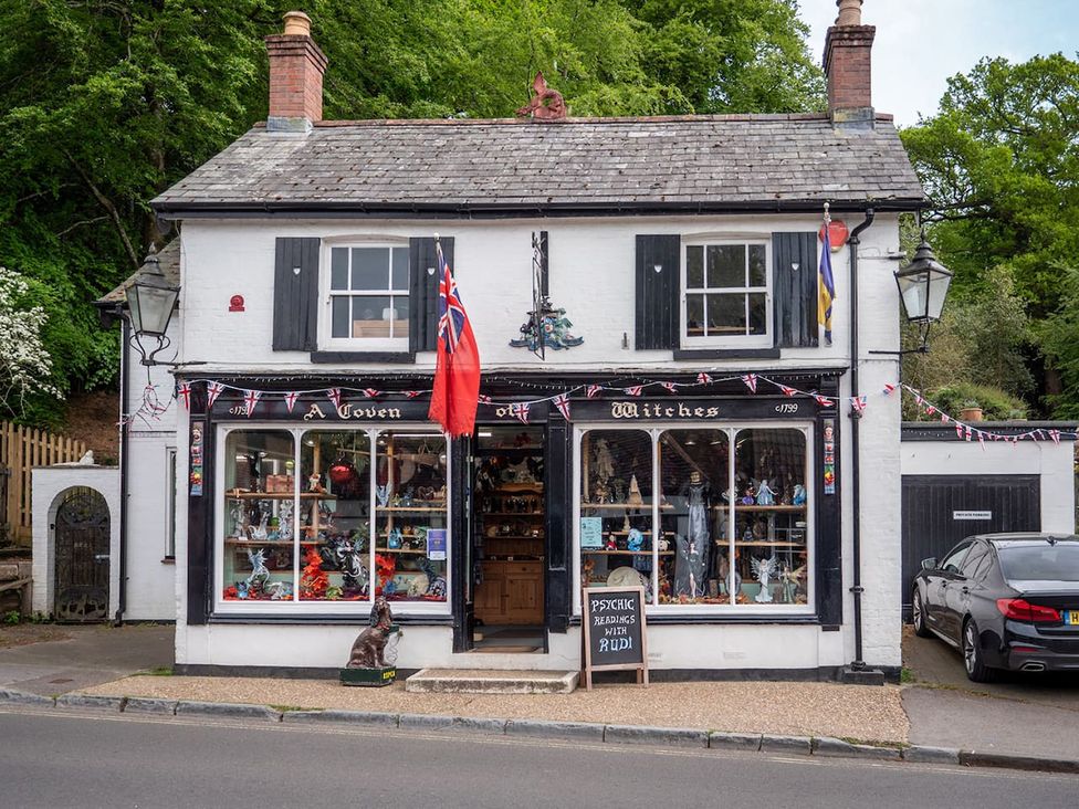 A shop with a sign at A Coven of Witches in an unspecified location
