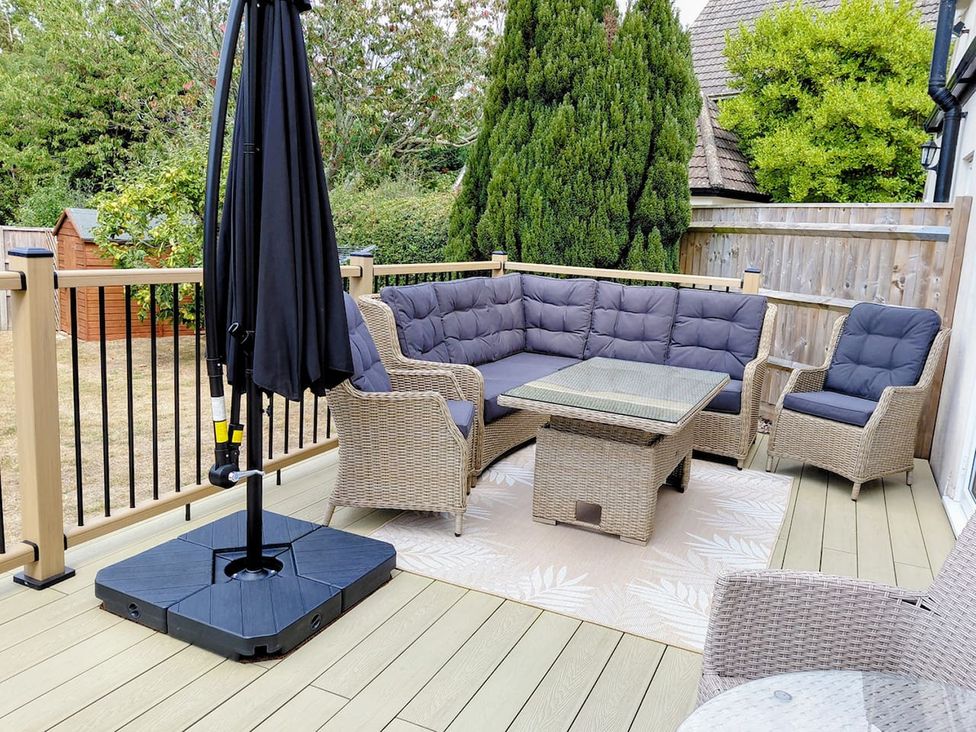 A patio with outdoor seating and an umbrella at a property in an unspecified location