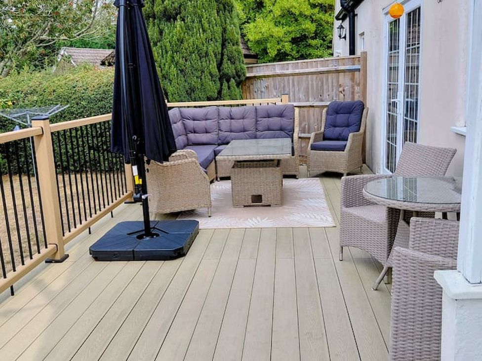 An outdoor patio with seating and a table at 