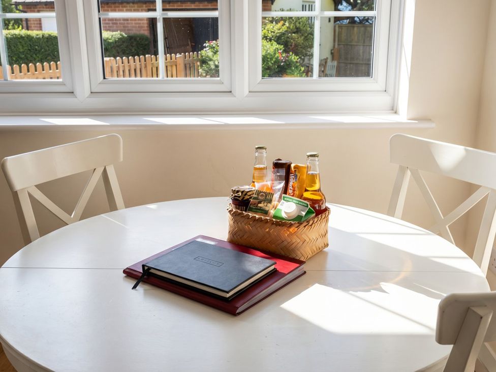 A dining room with a table, chair, bottle, basket at the property in unspecified location