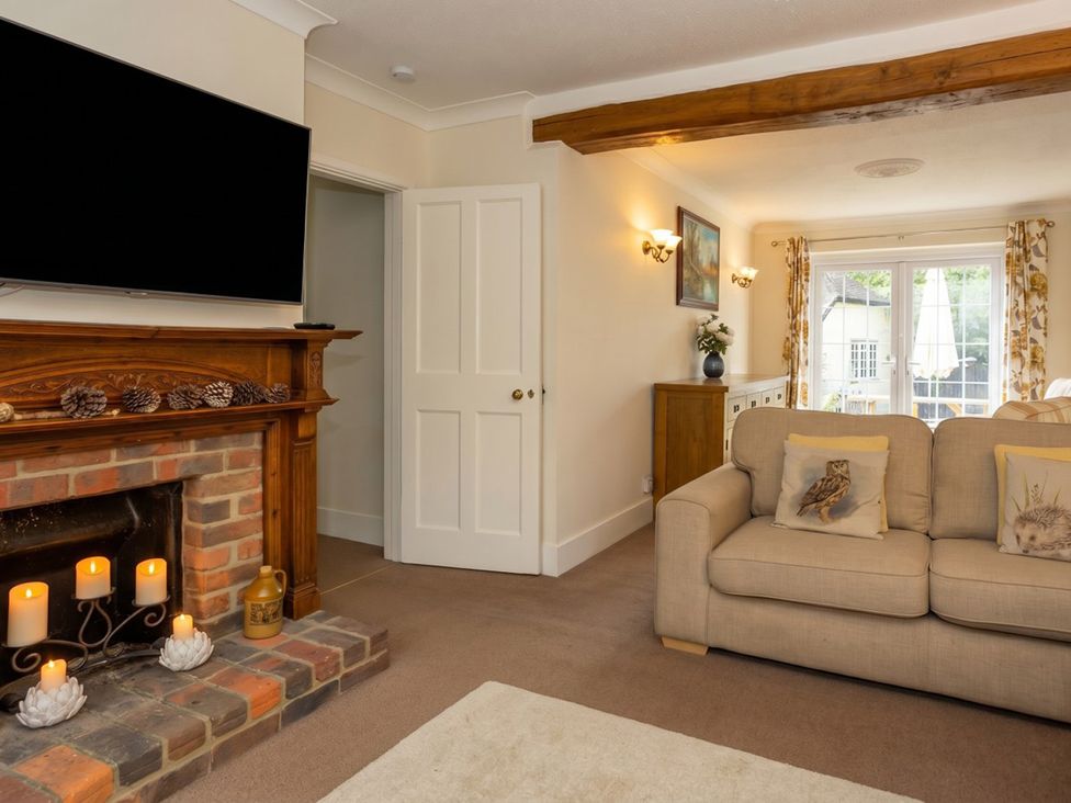 A living room with a television and a sofa at The Old Barn in Manchester
