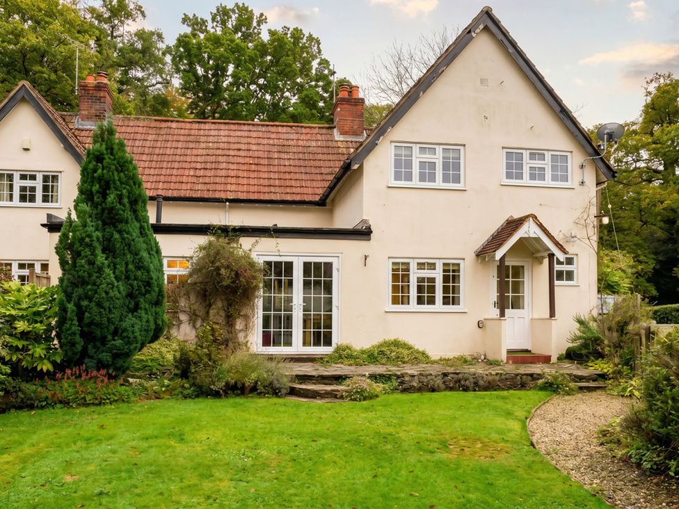 A house with windows and a door in a garden at 