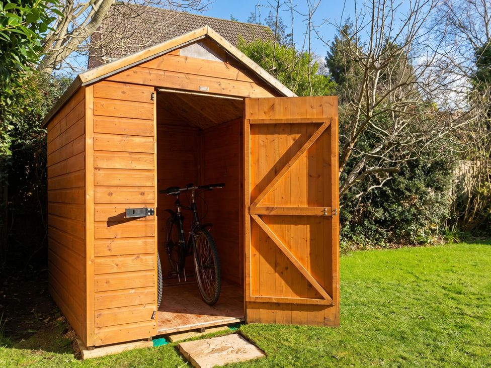 A garden shed with a bicycle inside at the property in the garden