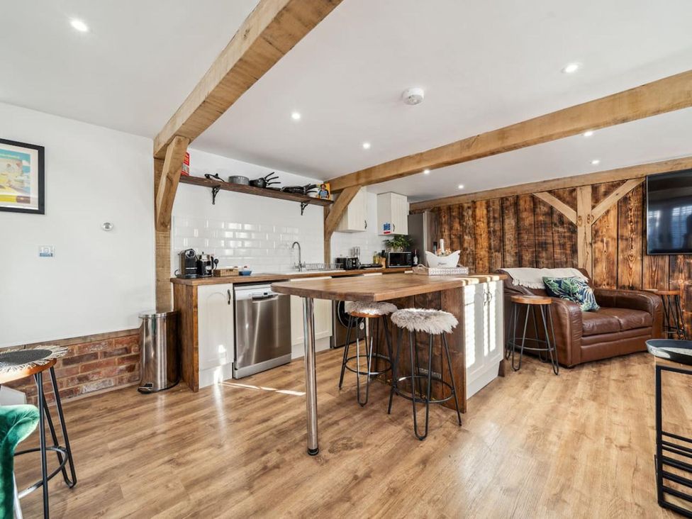 A kitchen with a counter and stools at a property in unspecified location