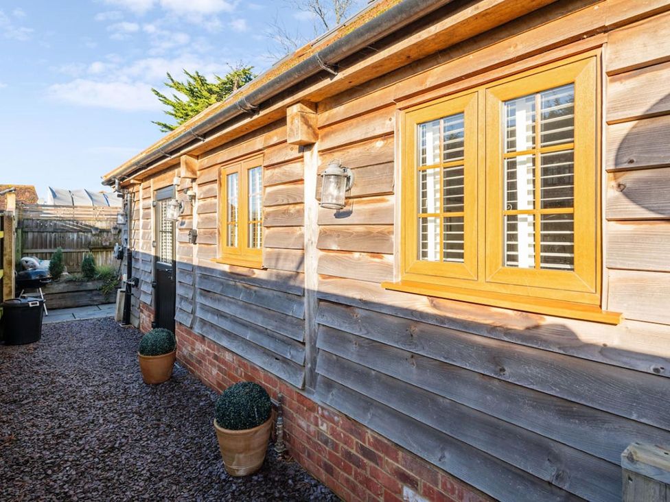 An exterior wall with windows and planters at The Old Barn in Manchester