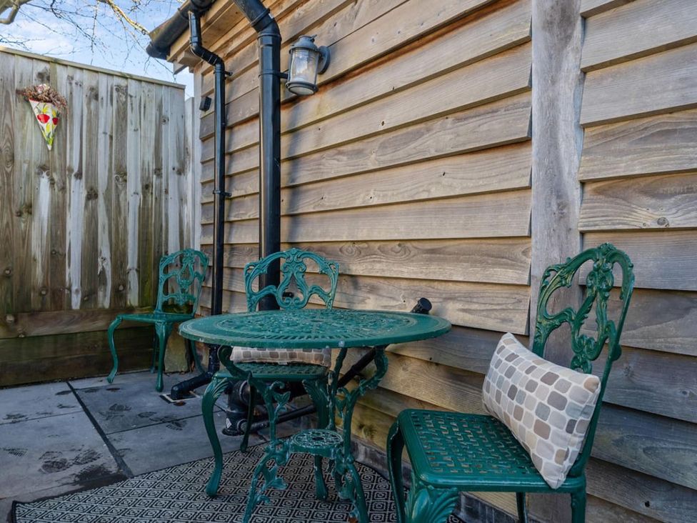 An outdoor patio with a table and chairs at an unspecified location