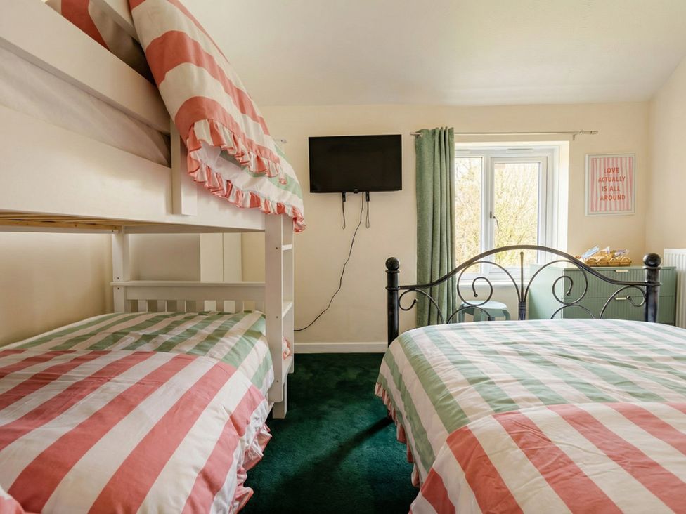 A bedroom with a bunk bed and a double bed at the property