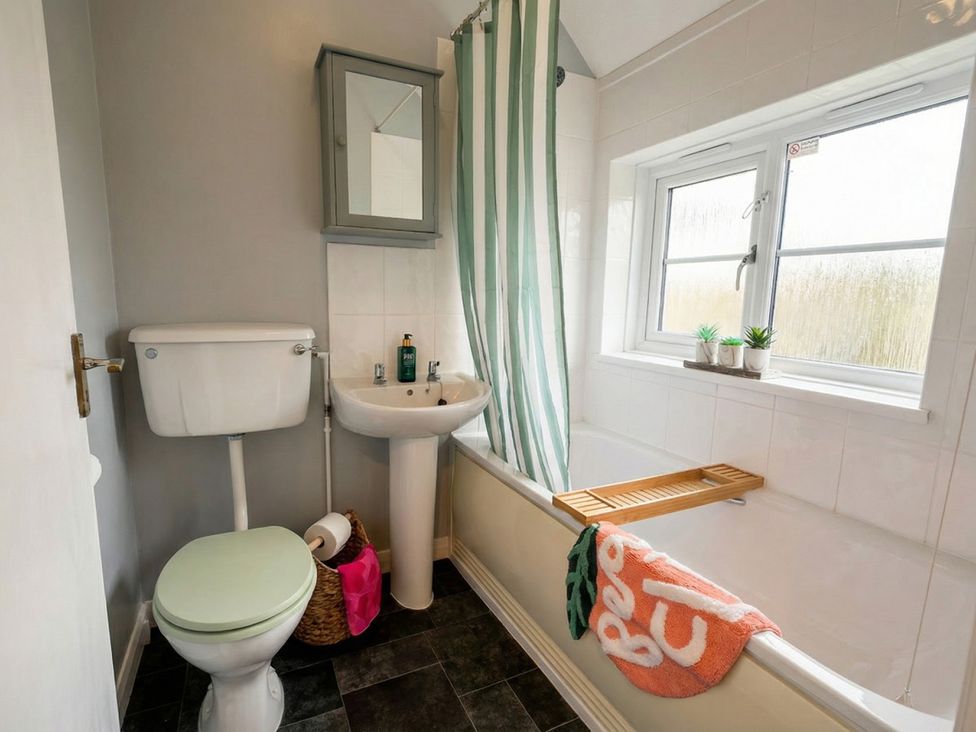 A bathroom with a toilet, sink, and bathtub at 