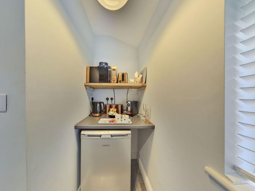 A kitchen with appliances and storage at 