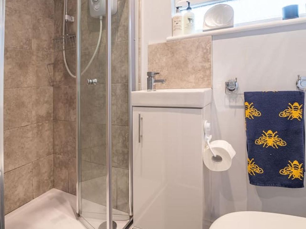 A bathroom with shower, toilet and sink at The Old Barn in Manchester