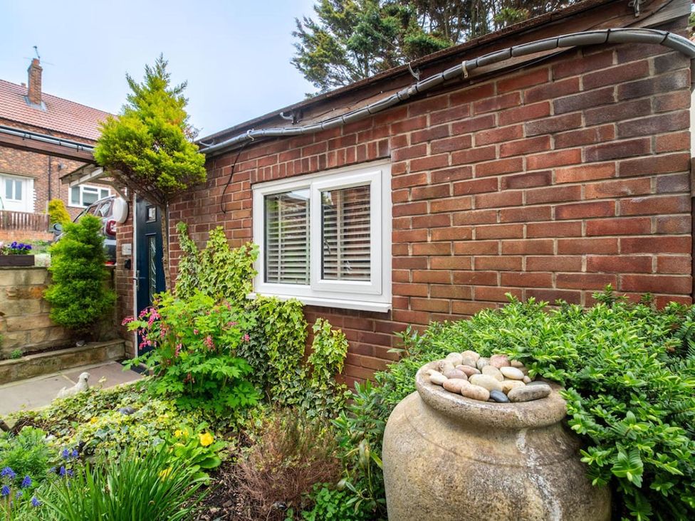 A garden with a brick wall and plants at a residential property in the UK