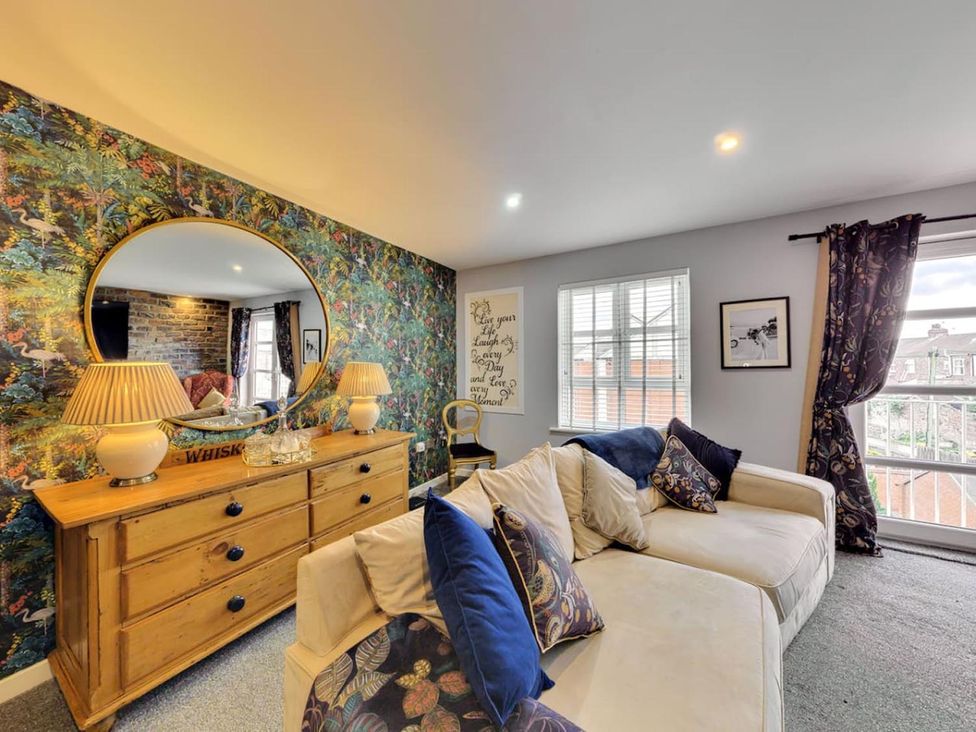 A living room with a sofa and sideboard at The Old Barn in Manchester