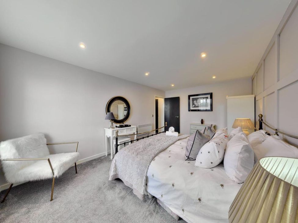 A bedroom with a bed and a nightstand at The Old Barn in Manchester
