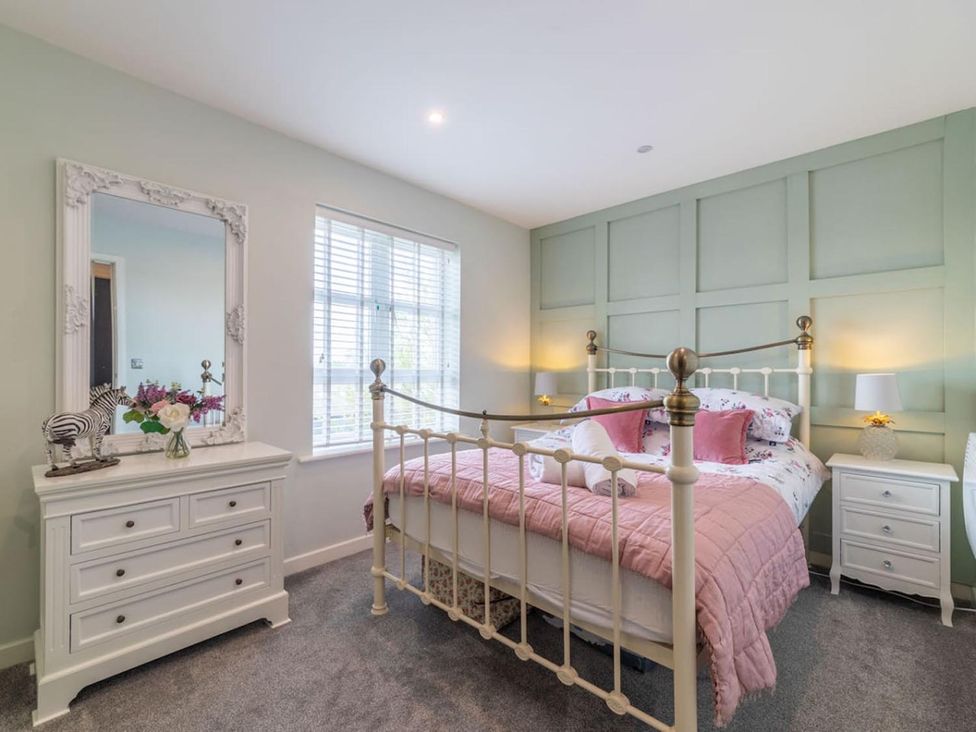 A bedroom with a bed and dresser at The Old Barn in Manchester