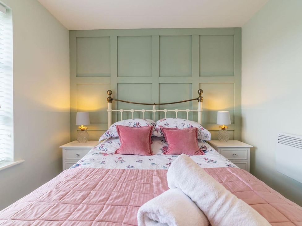 A bedroom with a bed and nightstands at The Old Barn in Manchester