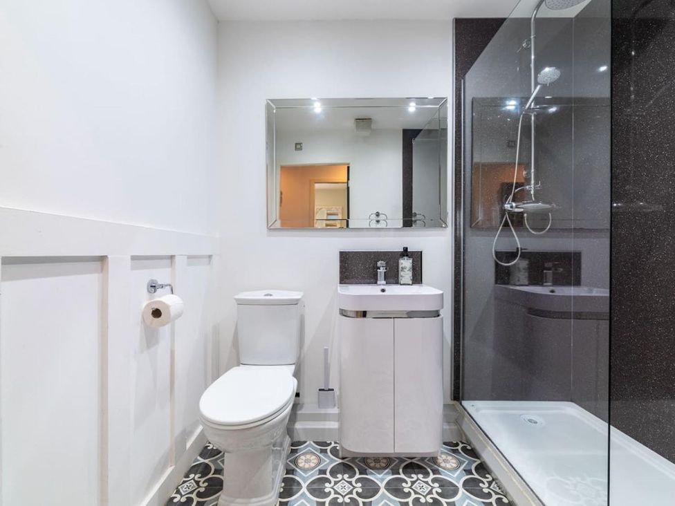 A bathroom with a toilet, sink and shower at The Old Barn in Manchester