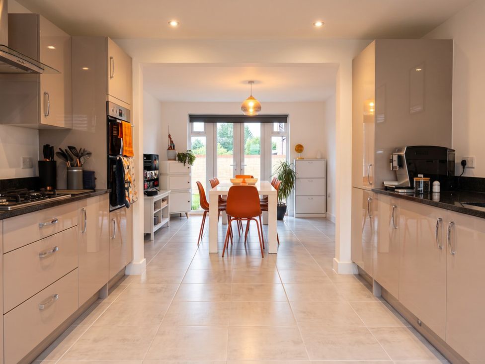 A kitchen with cabinets and a dining area at 