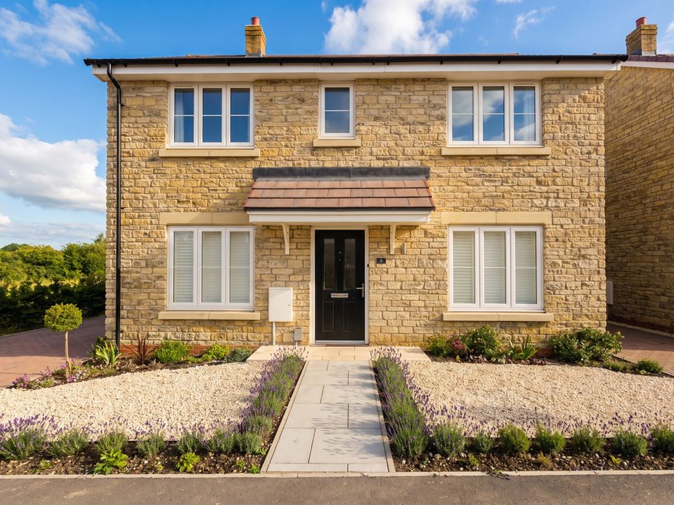 A house with multiple windows and a black front door at  in 
