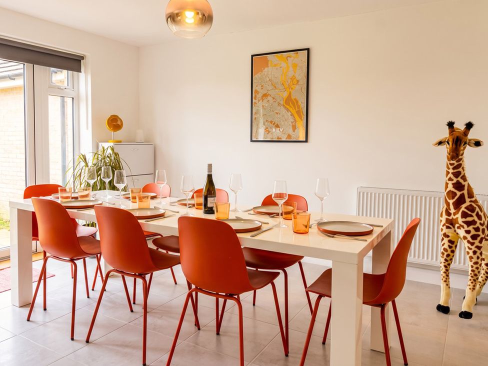 A dining room with a table set for meals at The Old Barn in Manchester
