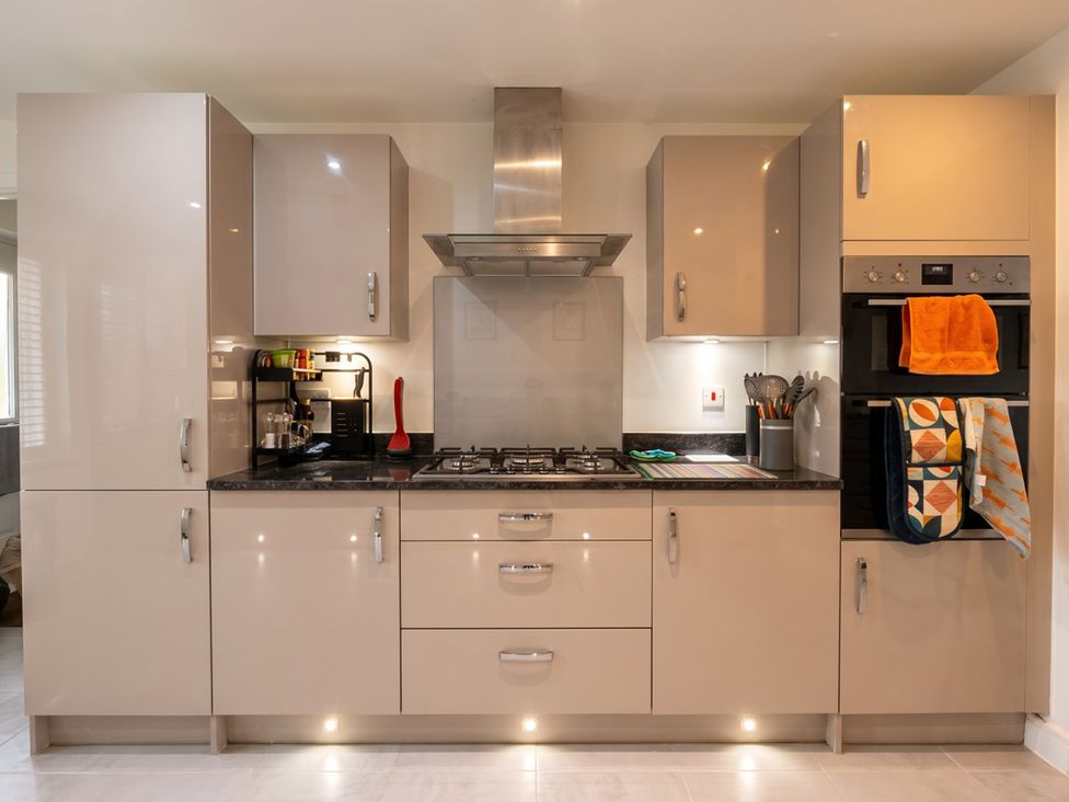 A kitchen with cabinets, stove, and oven at 