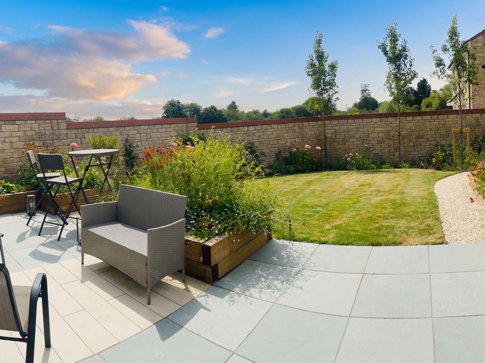 A garden with seating area and plants at the property