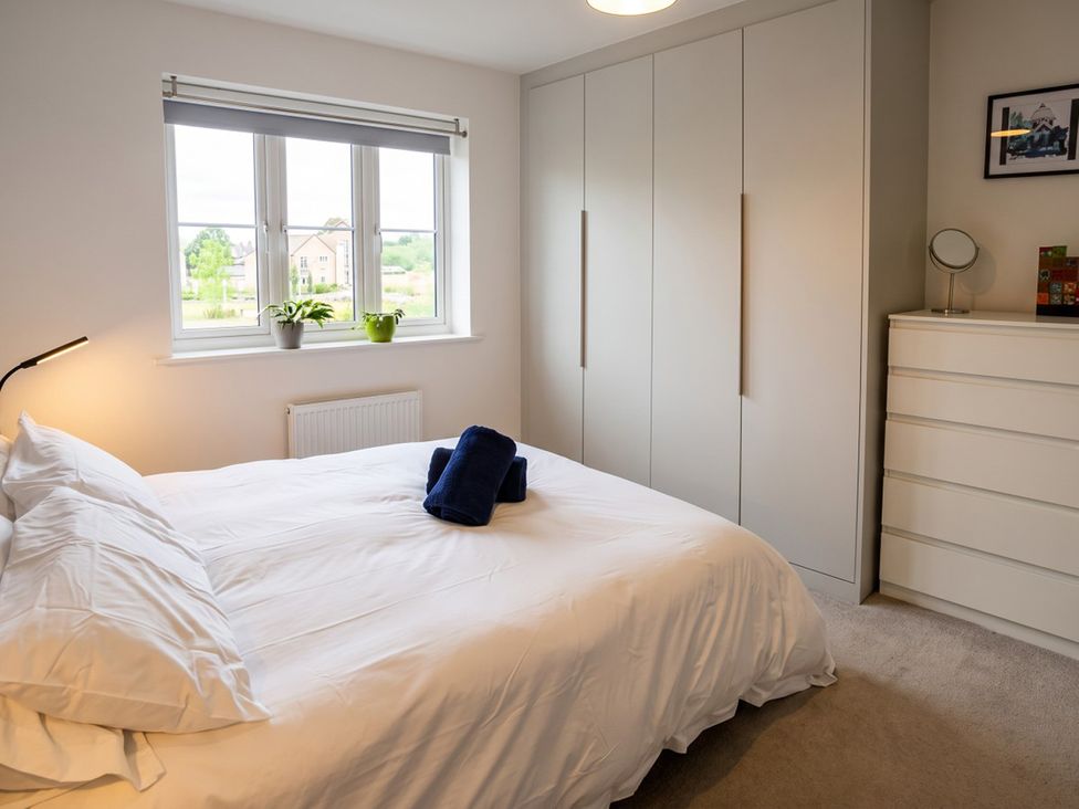 A bedroom with a bed and wardrobe at The Old Barn in Manchester