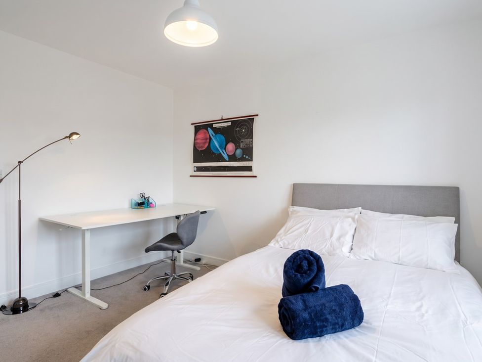 A bedroom with a bed and desk at The Old Barn in Manchester