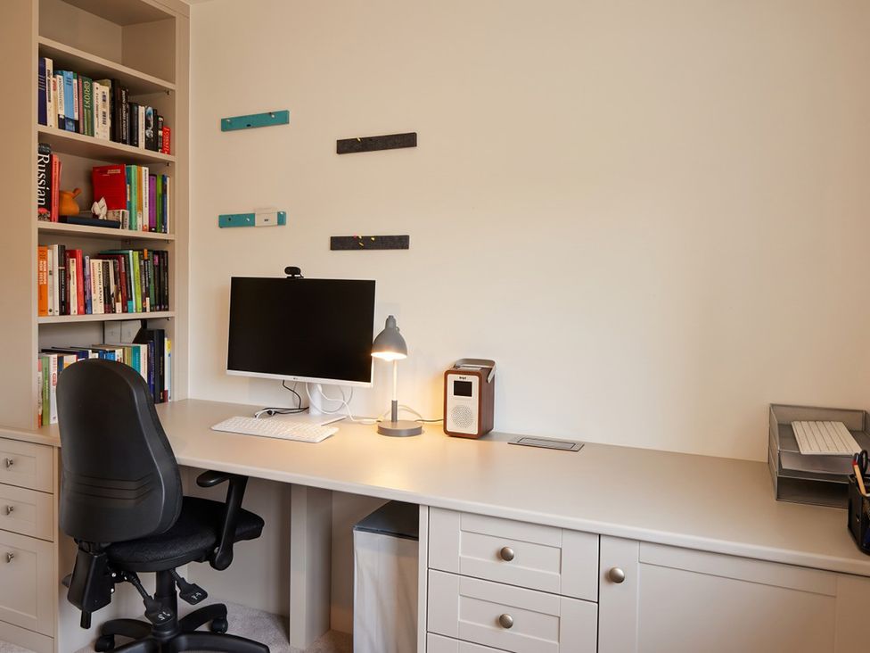 A home office with a computer and bookshelves at 