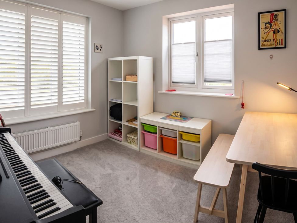 An office with a piano and desk at 