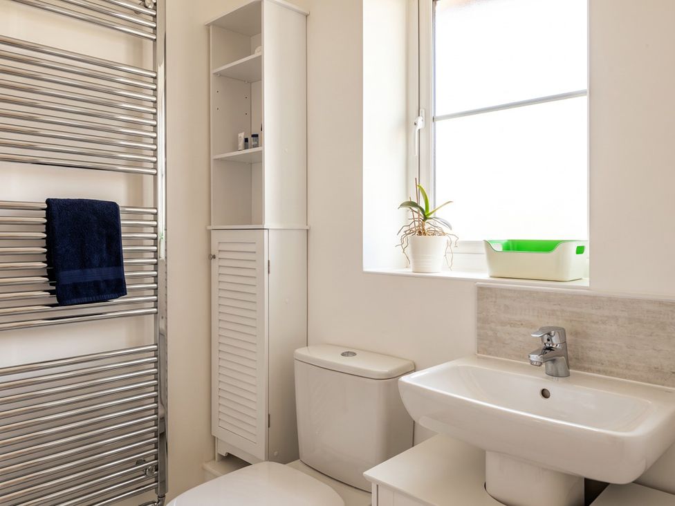 A bathroom with a towel rail, sink, and toilet at 