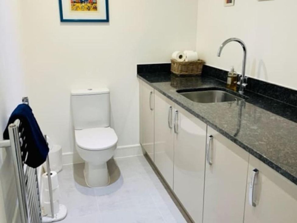 A bathroom with a toilet and sink at The Old Barn in Manchester