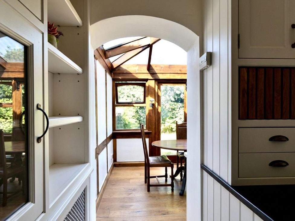 A kitchen area leading to a dining space at The Old Barn in Manchester