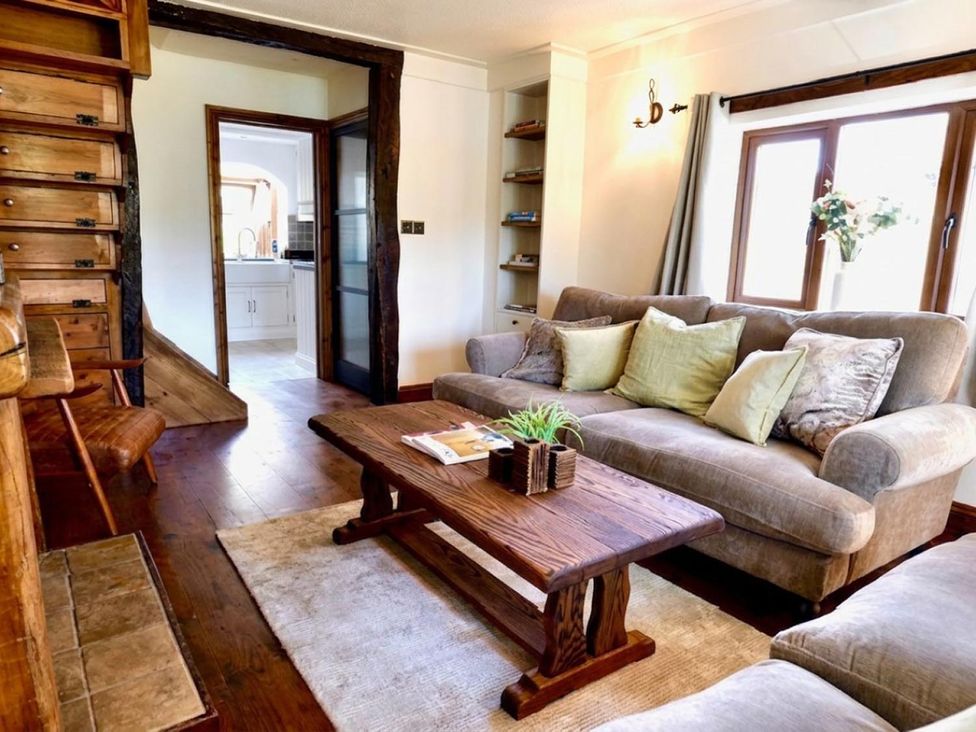 A living room with a sofa and coffee table at the property.