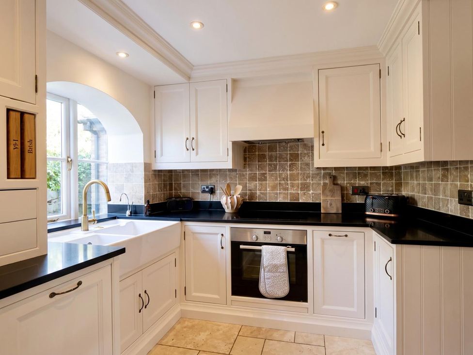 A kitchen with a sink and oven at the property.