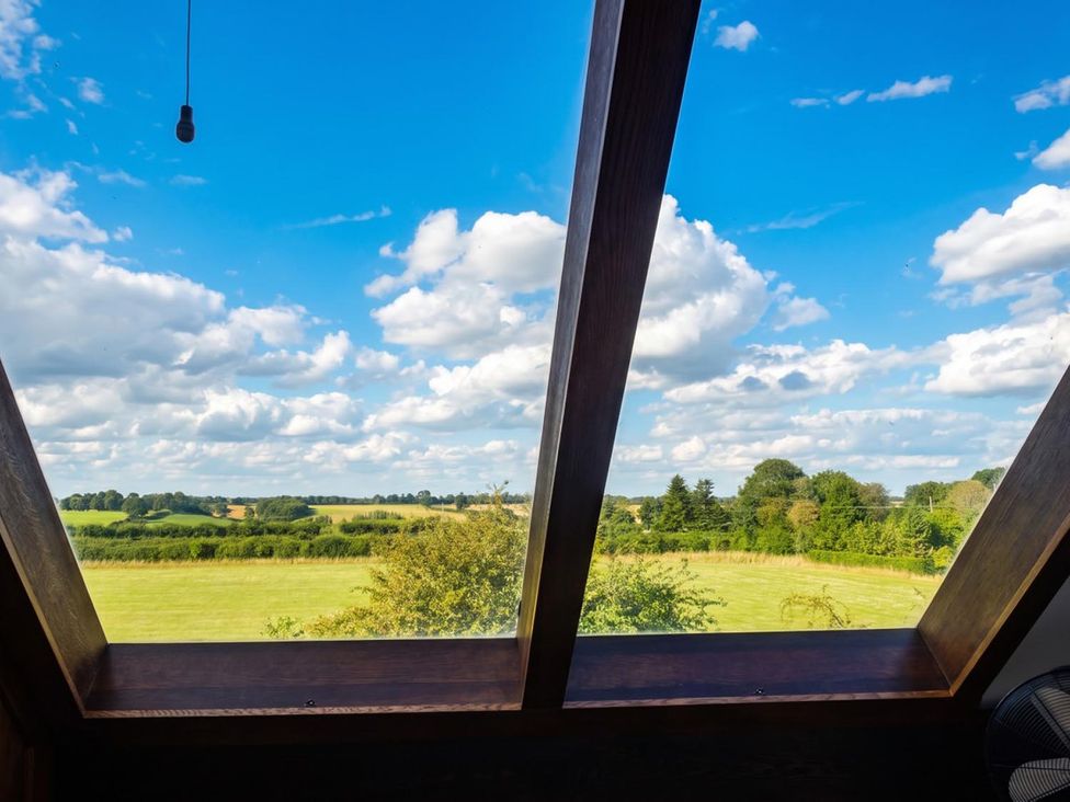 A view from a window overlooking a field and sky at 