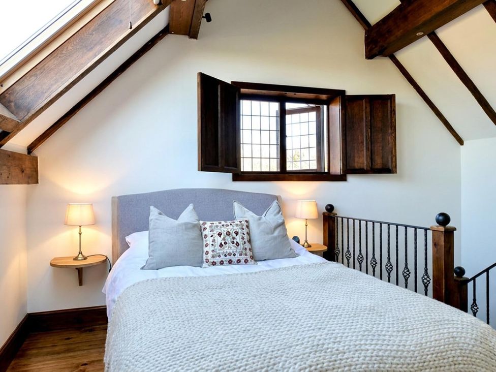 A bedroom with a bed and lamp at The Old Barn in Manchester