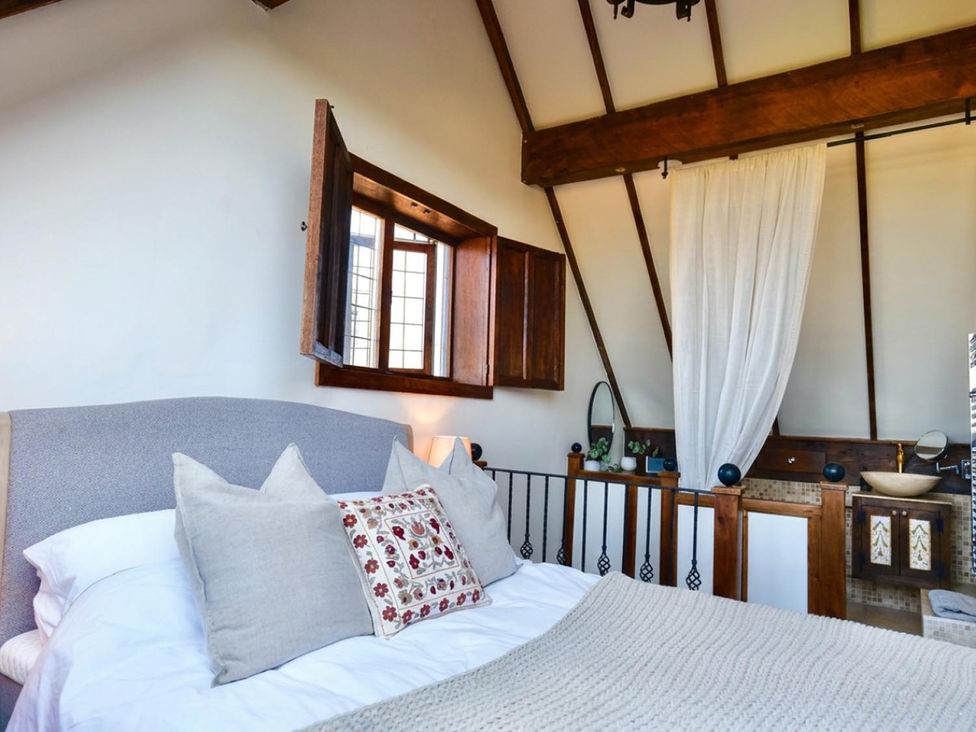 A bedroom with a bed and window at The Old Barn in Manchester