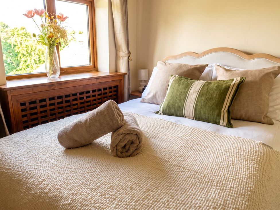A bedroom with a bed and decorative pillows at the property in location