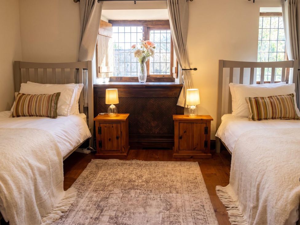 A bedroom with two beds and a window at The Old Barn in Manchester