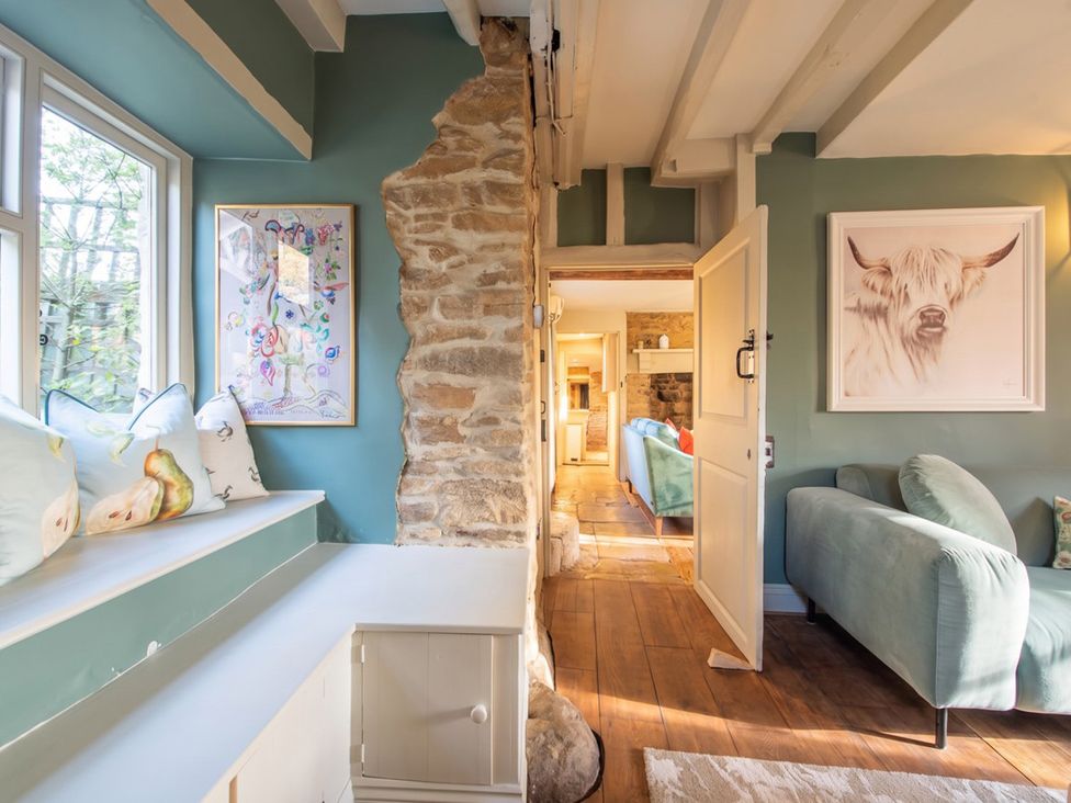 A living room with a stone wall and a couch at the property in 
